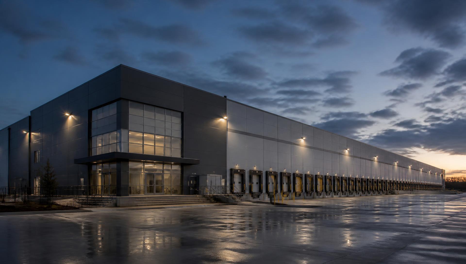Distribution and logistics facility exterior at dusk